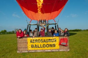 a family photographed in an aerosaurus balloon